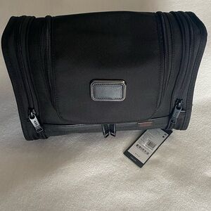 Black Tumi toiletry bag with leather
